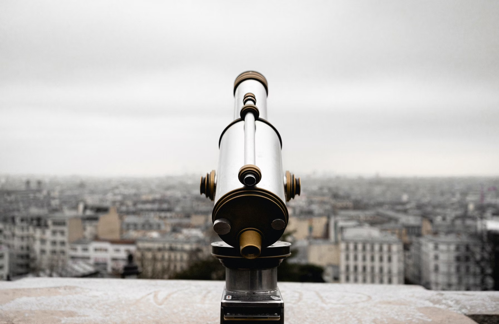 A telescope overlooking a city